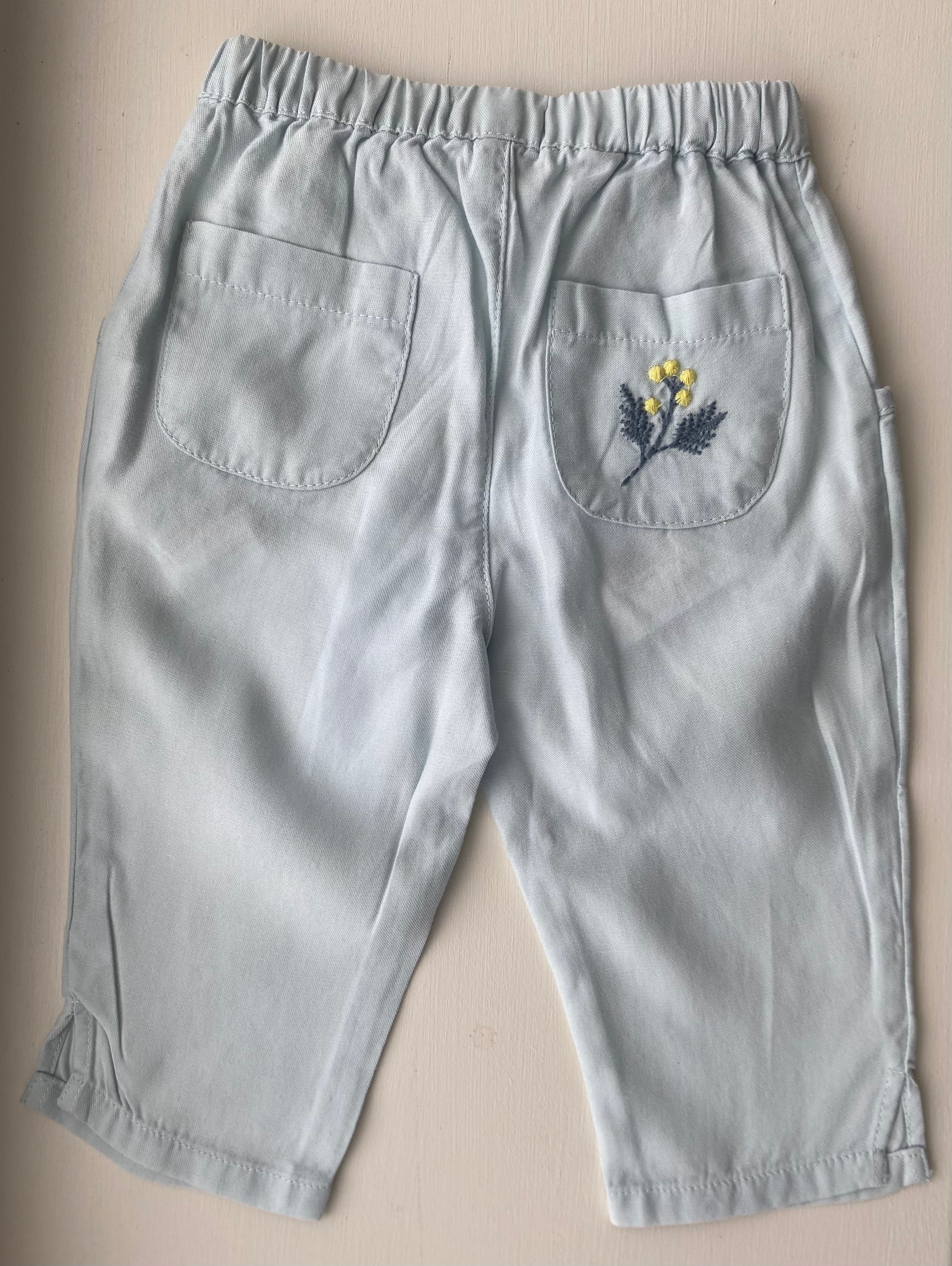 Aqua trousers with embroidered floral pocket